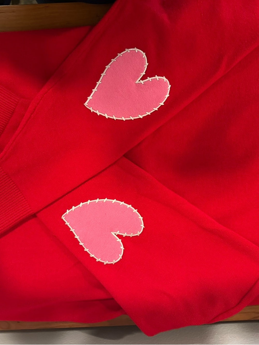 XOXO Red Sweater with Pink Heart Elbow Patches and “LOVE” stitching at collar.